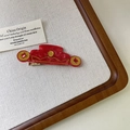 Close-up of red Chinese New Year duckbill hair clips with gold auspicious patterns - God of Wealth Hat