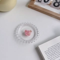 Mini pince à cheveux ours en acétate rose marbré présentée sur un plat - Rose