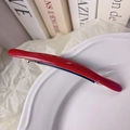 Glossy bright red oval acetate hair clip with gold label and silver spring metal clasp - Red