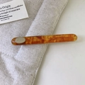 Vintage tortoiseshell resin hair clip with gold metal emblem on soft linen texture - Tortoiseshell Amber Style / Amber