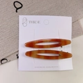 Set of two amber tortoiseshell acetate hair clips with hollow oval design on display card - Hollow Acetate Clip Set / Brown