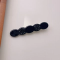Detailed close-up of a black acetate rose hair clip with elegant relief patterns - Rose Duckbill Clip / Black Rose