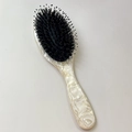 Dettaglio del manico in marmo e delle setole di cinghiale sulla spazzola per capelli - Beige
