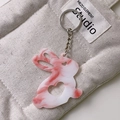 Dettaglio portachiavi a forma di coniglio in acrilico marmorizzato su borsa grigia - Rosa Marmorizzato