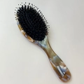 Detail of premium anti-static cushion hairbrush with boar bristles and marbled handle - Blue Brown