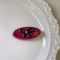 Detail of burgundy oval hair clip with black bow and gold France Handmade lettering - Red