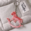 Pink marble pattern rocking horse keychain made of acrylic on a beige quilted bag - Marble Pink