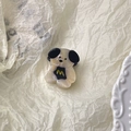 Detailed macro view of the cute cartoon dog hair claw clip with a glossy pearl finish - Beige