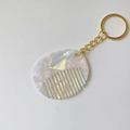 Macro shot of acetic acid mini comb keychain with a marbled pearlescent acrylic texture - Mermaid Color (Gold Keychain)