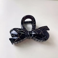 Detailed close-up of glossy black lace-patterned bow hair claw clip with golden veins - Bowtie / Black