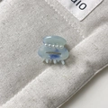 Detailed macro view of a mini blue marble hair claw clip with four white pearls - Approx 2.5cm / Blue
