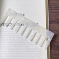 Detail of cellulose acetate wide-tooth comb with shell texture resting on a vintage book - White