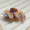 Orange and white checkered acetate hair claw clip with blue wavy patterns on beige tray - Lightning Plaid (21#)