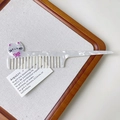 Close-up of cat-shaped hair comb with cream marble texture and pink bow detail - White Cat Style (S113)