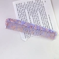 Acetate hair comb with purple and pink terrazzo marble pattern on an open book - Floral Purple