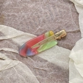 Macro shot of colorful acetate hair clip on textured stone and tissue paper background - Green Pink