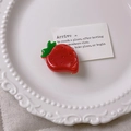 Cute red strawberry hair claw clip made of acetic acid resin on a white plate - Strawberry