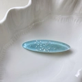 Macro shot of ocean-themed oval hair clip with iridescent pearl fragments in blue resin - Blue