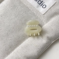 Mini cream resin hair claw clip featuring four pearls on textured canvas background - Approx 2.5cm / Mermaid White