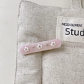Close-up of pink resin hair clip with white floral 3D details and sparkling rhinestones - Light Pink