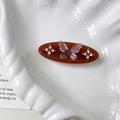 Elegant amber brown oval hair clip featuring a clear resin butterfly and sparkling rhinestones - Brown