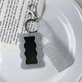 Close-up of glittery silver mini comb and mirror keychain accessory on white tray - Comb 9.3cm*3.5cm Mirror 5.8cm*3.7cm 22g / Gray