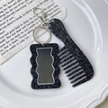 Detail of a vintage black glitter comb and mirror keychain on an elegant ceramic plate - Comb 9.3cm*3.5cm Mirror 5.8cm*3.7cm 22g / Black