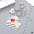 Macro detail of a white rabbit-shaped acetate comb keychain with a red bow and heart charms - Rabbit / Rabbit Comb Pendant (K4952)