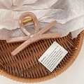 Macro detail of nude pink bow hair claw with gold spring mechanism and glossy finish - Large / Lotus root pink