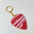 Detail of red and white marbled acrylic guitar pick keychain with a gold ring - Texture Pink With Gold Buckle