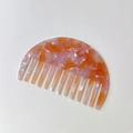 Semicircle acetate hair comb featuring orange and pink marble pattern with wide teeth - Orange