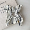 Detailed view of blue striped scrunchie with elegant golden heart charm and polka dots - Cream Striped Style