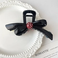 Elegante pinza per capelli a fiocco nero con bottone a pois rossi su piatto di ceramica - Stile di base / Nero