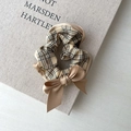 Plaid scrunchie with khaki satin bow shown on a linen texture background - Checkered With Bow Style