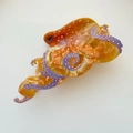 Macro detail of octopus hair claw clip featuring orange acetate and purple tentacles - Orange / Large