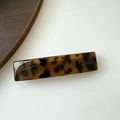 Macro view of a rectangular tortoiseshell pattern hair clip with a polished finish - Narrow Tortoiseshell