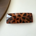 Detail of a square leopard print hair clip with a glossy tortoise shell pattern finish - Wide Deep Tortoiseshell