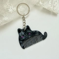 Detail showing marble texture black cat comb keychain with silver metal ring and chain - Approx: 5.4cm*3.7cm / Silver Chain - Black