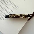 Rectangle acetate banana hair clip with marbled tortoise shell pattern on vintage book - Milk Coffee