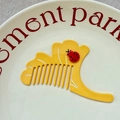Detailed macro view of a yellow ginkgo leaf comb featuring a cute 3D ladybug decoration - Approx. 9.9cm*5cm