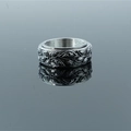 Vintage stainless steel spinner ring with relief eye patterns on a mirrored background - US 7 / Vintage Steel Silver