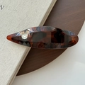 Elegant amber tortoiseshell hair clip with streamlined oval resin design and metal spring - Deep Shiny Tortoiseshell