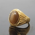 Vintage gold-plated ring with oval tiger eye stone and intricate embossed textures - Size 7 / Gold Tone Brown Artificial Cat's Eye Stone