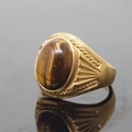 Vintage gold-finished titanium ring featuring a large oval brown tiger's eye gemstone - Size 7 / Gold Base Tiger Eye Stone