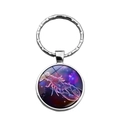 Detail of round glass dome keychain featuring a glowing red lobster on star galaxy background - Cancer