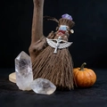 Detail of mini Wicca besom with natural crystals and silver goddess charm on stone surface - Silver Winged Goddess Style (09)