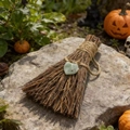 Detail of handmade witch broom with green heart crystal on rock with pumpkins - Green Fluorite / 10cm