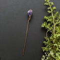 Detailed close-up of handmade copper wire hair pin with a raw purple crystal stone top - Amethyst