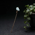 Detail view of handmade gold hair pin featuring raw light blue natural crystal stone - Amazonite