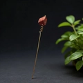 Handcrafted natural red gemstone hair pin with gold wire wrapping on black background - Red Jasper